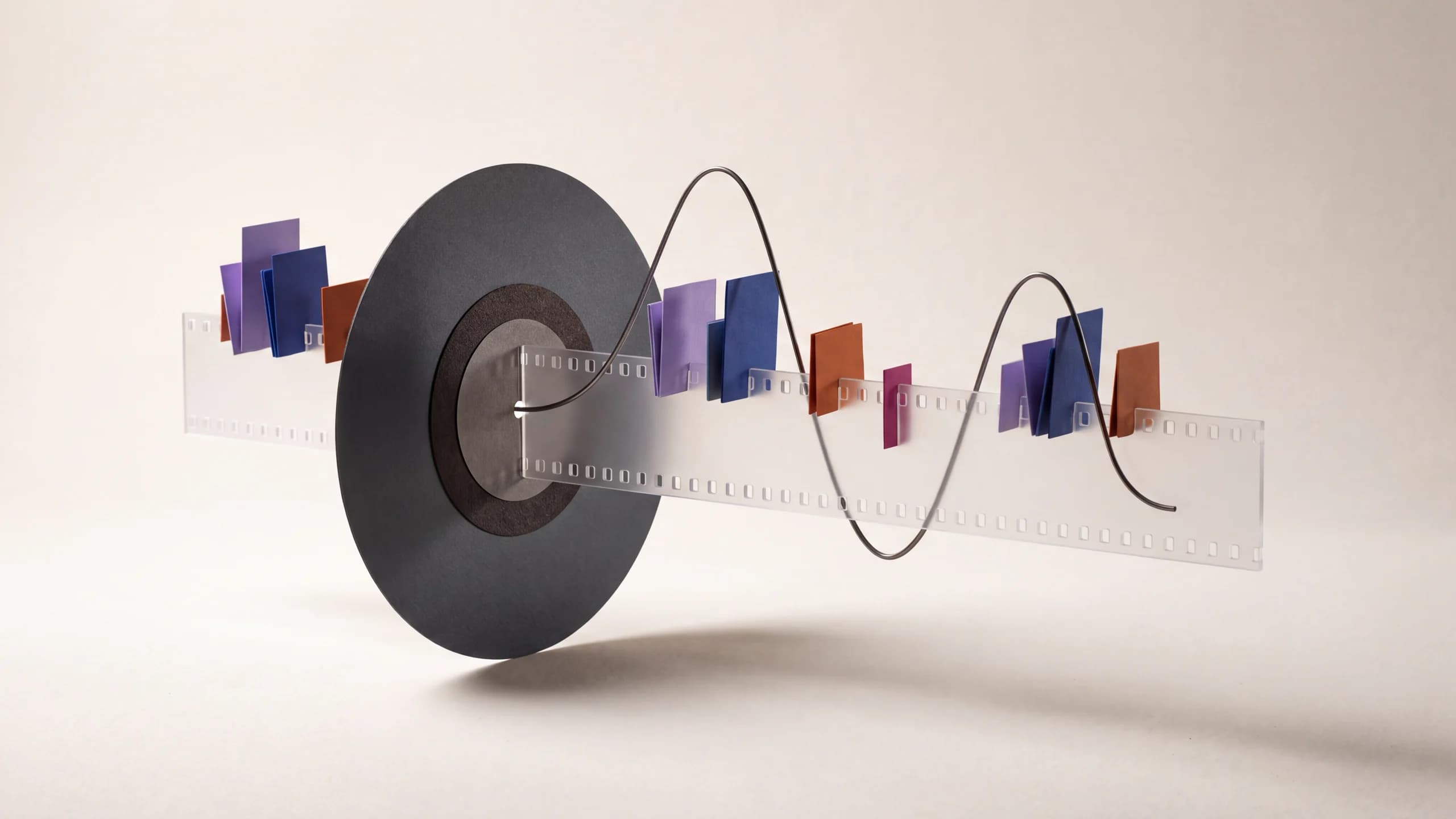 A tactile vinyl record, filmstrip, and wire waveform arranged as an editorial still life